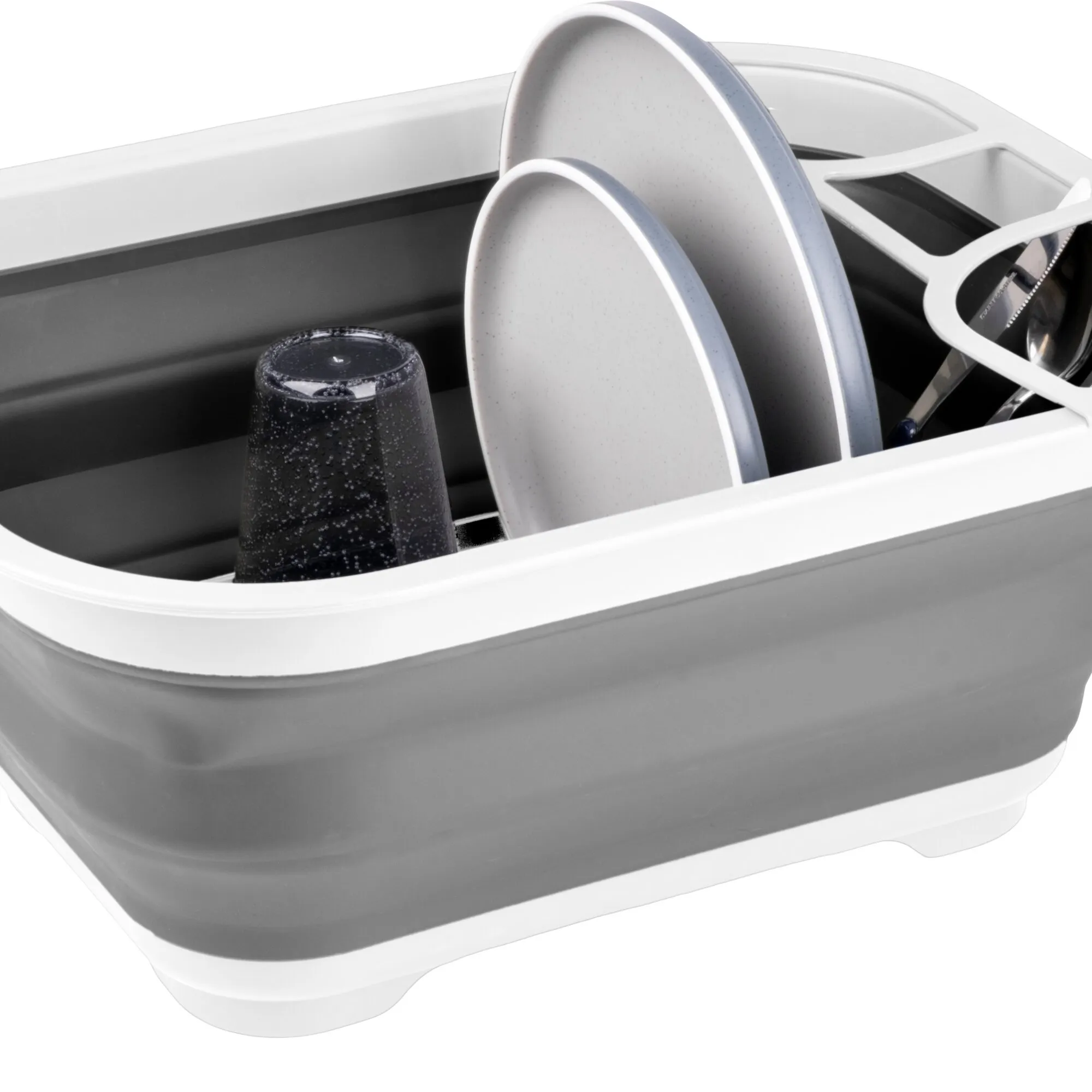 Faltbarer grauer Geschirrabtropfer Dishaway mit Tellern, umgedrehtem Glas und Besteck in einer Spüle