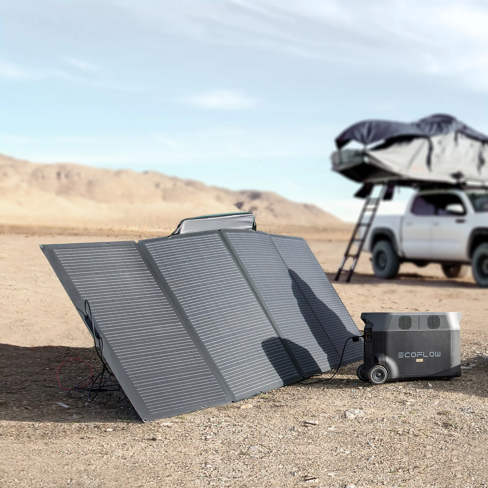 Faltbares 400-Wp-Solarmodul im Wüstengelände, angeschlossen an eine EcoFlow-PRO-Powerstation neben einem Geländewagen