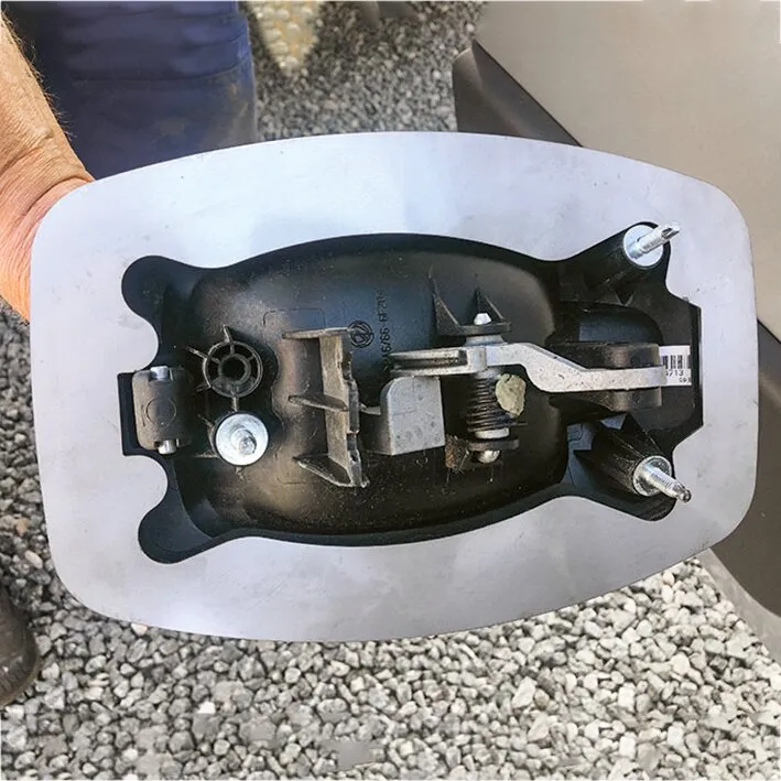 Silberne Stechschutzplatte für die Griffschale eines Eurochassis mit schwarzem Griffmechanismus und Befestigungselementen in Innenansicht