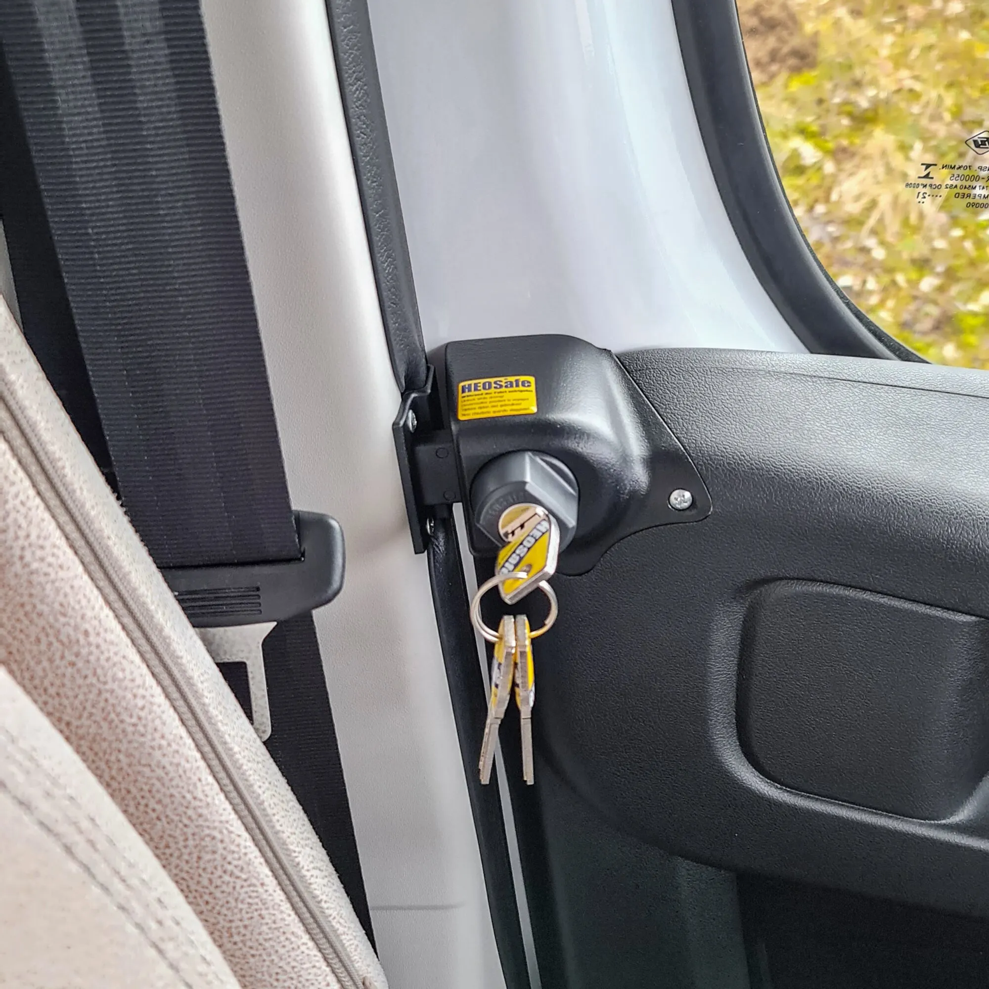 Schwarzes Diebstahlschutzschloss mit Schlüssel an der Fahrerhaustür eines Fiat Ducato X290, Detailansicht aus dem Innenraum